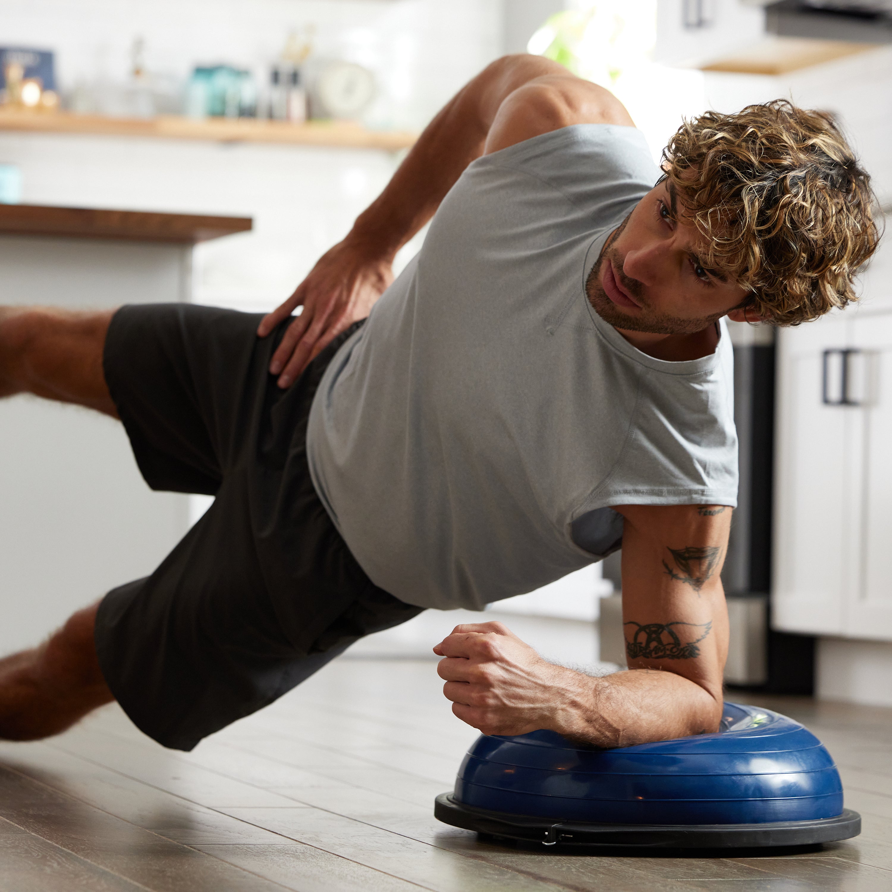 Person in Side Plank with forearm on the Balance Trainer Sport